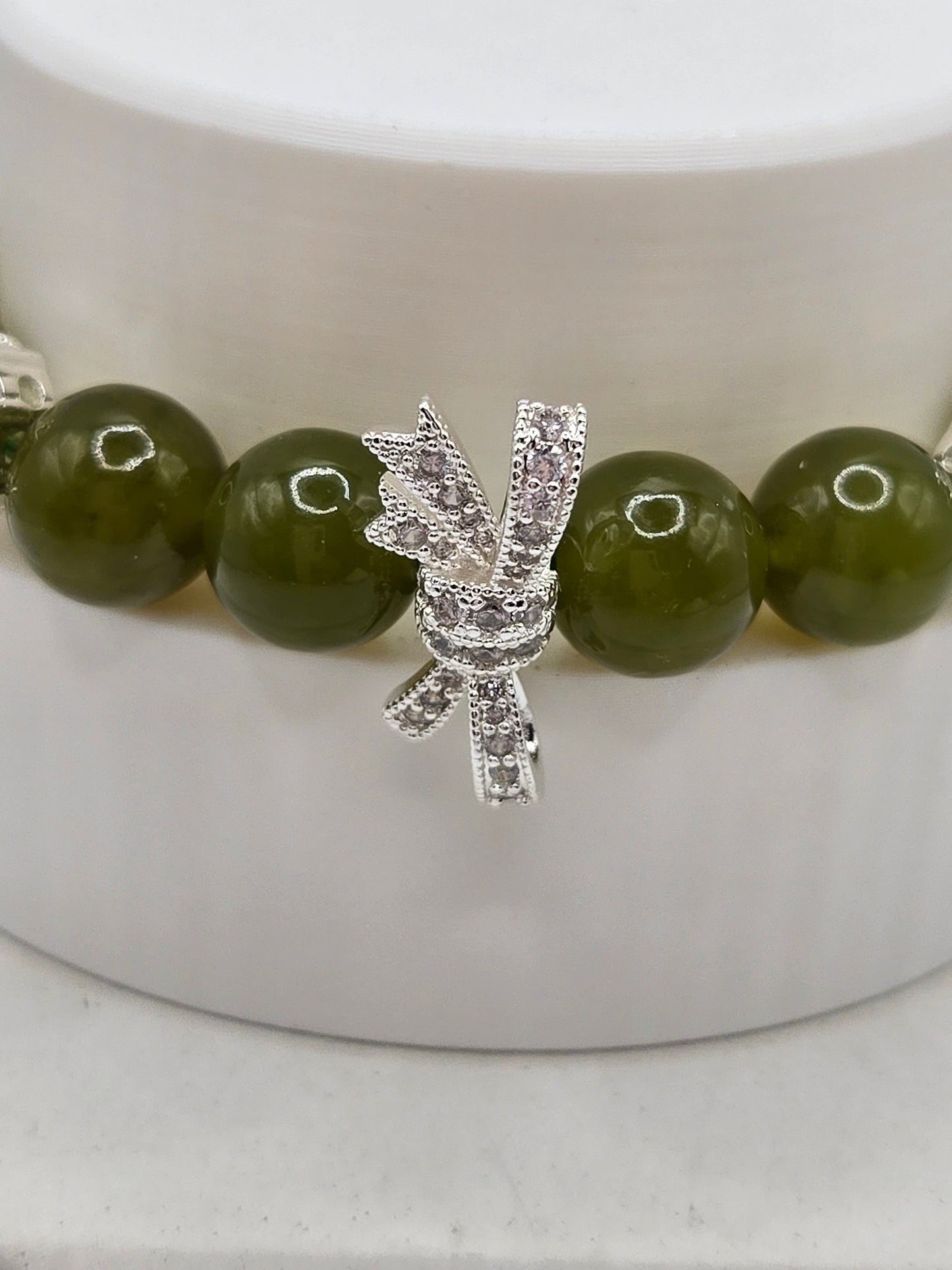 Olive Green Serpentine Bracelet with Sparkly Bow Charm – Elegant & Playful